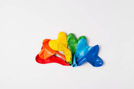 Rainbow balloon hearts for decoration in LGBT colors. Set of isolated heart shaped deflated balloons for greeting card for Pride month celebration on white background. Copy space