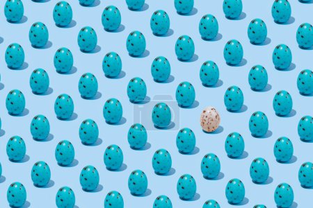 Pattern of  blue shiny Easter egg casting shadow on blue background, minimalism concept, copy space