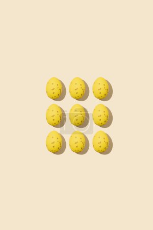 Photo for Pattern of beautiful yellow chicken eggs for Easter on yellow background, top view - Royalty Free Image