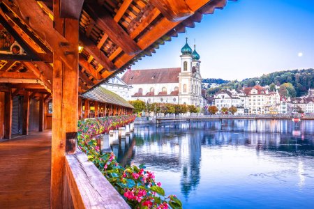 Photo for Chappel bridge historic wooden landmark in Luzern and town riverfront view, town in central Switzerland - Royalty Free Image
