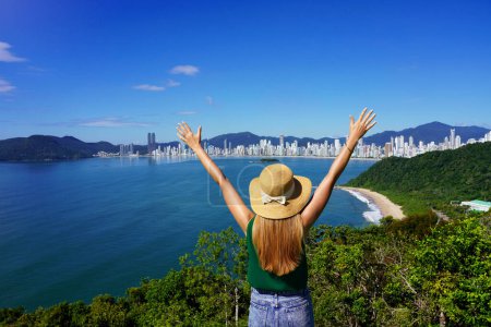 Excited carefree woman raising arms on top view cityscape. Vitaly people. Leisure activity. Freedom. Success.