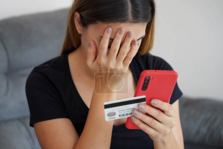 Digitaler Diebstahl. Verzweifelte junge Frau findet heraus, dass ihre Kreditkarte geklont und ihr Bankkonto geleert wurde. Cyber-Sicherheitskonzept.