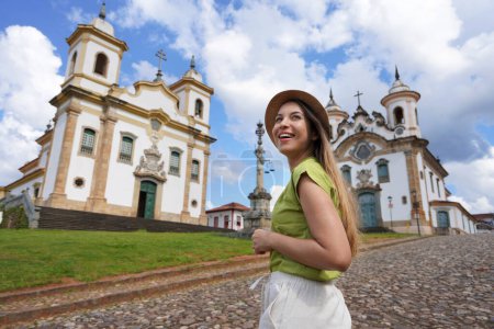 Photo for Tourism in Mariana, Minas Gerais, Brazil. Traveler girl visiting the historical town of Mariana with baroque colonial architecture. Mariana is the oldest city in the state of Minas Gerais, Brazil. - Royalty Free Image