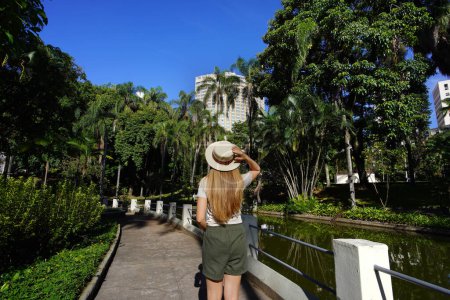 Visiting Belo Horizonte, Brazil. Back view of young woman in the Municiapl Parque Americo Renne Giannetti, a city park in Belo Horizonte, Minas Gerais, Brazil.
