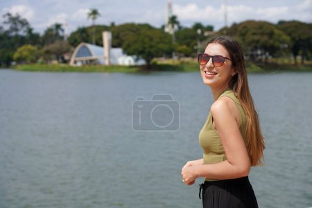 Vacation in Brazil. Traveler woman on Pampulha Lake in Belo Horizonte, UNESCO World Heritage Site, Minas Gerais, Brazil.