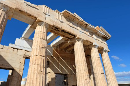 Up view to The Propylaea columns, the monumental gateway that serves as the entrance to the Acropolis in Athens, Greece.