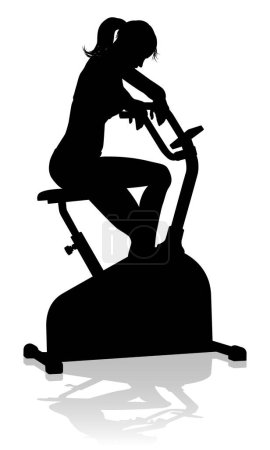 A woman in silhouette using a stationary exercise spin bike piece of gym equipment fitness machine