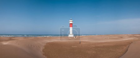 Photo for Panorama of lighthouse on a sunny day in Punta del Fangar. Ebro Delta. Spain. High quality photo - Royalty Free Image