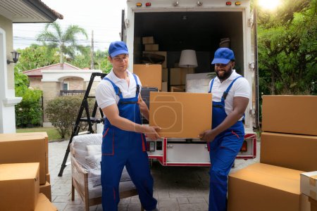 Photo for Workers unloading boxes from van outdoors. Moving service and customer need for move to new house - Royalty Free Image