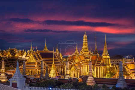 grand palace and wat phra kaew in Bangkok city with sunset sky from roof top of building, Thailand