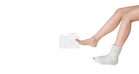 Photo for Closeup photo of broken female leg. Elbow crutches and orthopedic plaster. White ankle and foot splint bandages on the leg. Young woman's fall accident. Injury, trauma, recovery concept. Copy space - Royalty Free Image