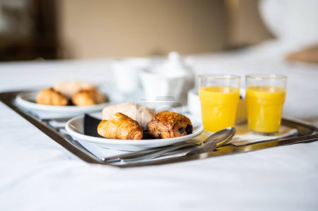 Photo for Continental breakfast coffee milk orange juice and croissant - Royalty Free Image