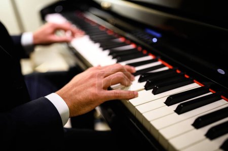 Photo for Close up of a musician playing a piano keyboard - Royalty Free Image
