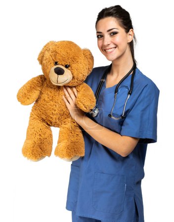 Foto de Hermosa enfermera sosteniendo un oso de peluche, concepto pediatra - Imagen libre de derechos