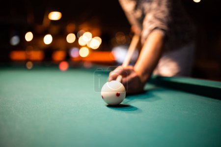 Photo for Young man playing snooker, aiming. for a good shot - Royalty Free Image