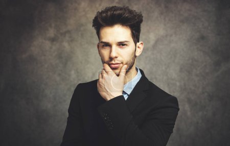 Photo for Young businessman in a thoughtful expression - Royalty Free Image