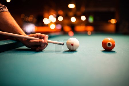 Photo for Young man playing snooker, aiming. for a good shot - Royalty Free Image