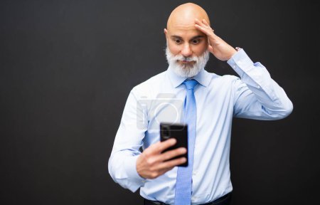 Photo for Man reading bad news on the cellphone - Royalty Free Image