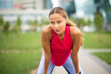 Photo for Beautiful woman tired during jogging in the city - Royalty Free Image
