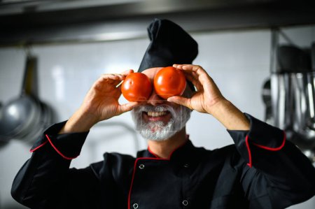 Photo for Funny chef covering his eyes with tomatoes - Royalty Free Image