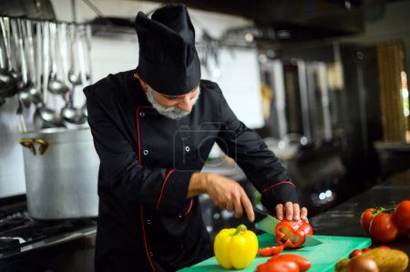 Photo for Chef cutting a red pepper - Royalty Free Image