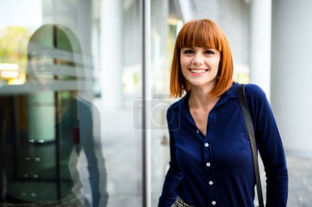 Photo for Confident young redhead female manager outdoor in a modern urban setting - Royalty Free Image