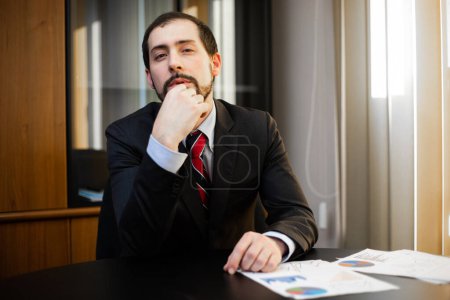 Photo for Thoughtful manager in his office - Royalty Free Image
