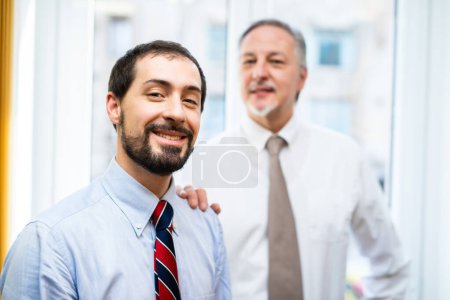 Photo for Senior manager putting his hand on a colleague's shoulder - Royalty Free Image