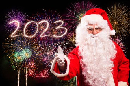 Photo for Santa Claus in front of fireworks, Christmas and new year 2023 concepts - Royalty Free Image
