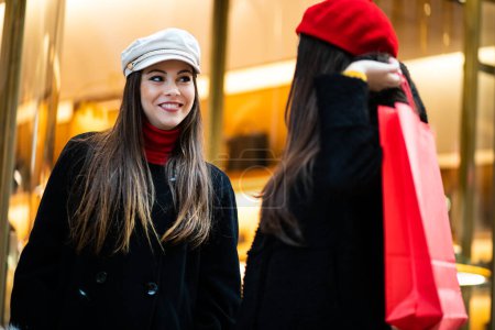 Photo for Two attractive smiling young women are shopping in the city - Royalty Free Image