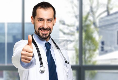 Photo for Handsome doctor portrait giving thumbs up - Royalty Free Image