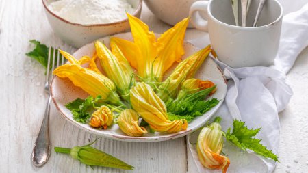 Ingredientes para la flor de calabacín frito como merienda vegetariana. Flor de calabaza frita en masa de panqueque.