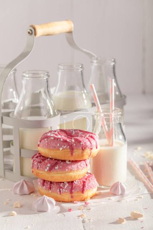 Fresh and tasty pink donuts as after school milky snack. Best tastes with milk. Most popular dessert.