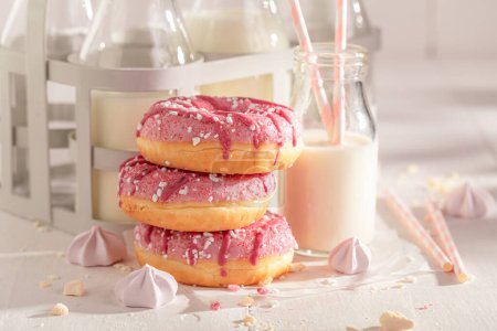 Yummy and homemade pink donuts as after school milky snack. Best tastes with milk. Most popular dessert.