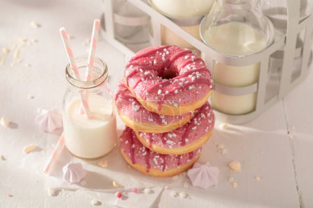 Fresh and tasty pink donuts served with milk in bottle. Served with milk. Most popular dessert.