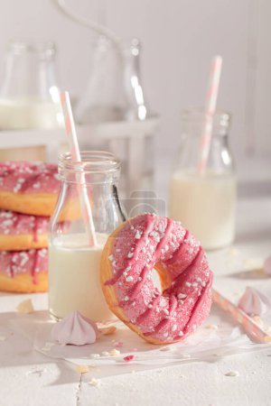 Sweet and delicious pink donuts with sprinkles and glaze. Best tastes with milk. Most popular dessert.