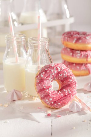 Yummy and homemade pink donuts as a lunch snack. Best tastes with milk. Most popular dessert.