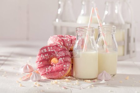 Sweet and delicious pink donuts as a lunch snack. Best tastes with milk. Most popular dessert.