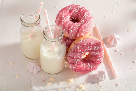 Yummy and homemade pink donuts ready to eat. Best tastes with milk. Most popular dessert.