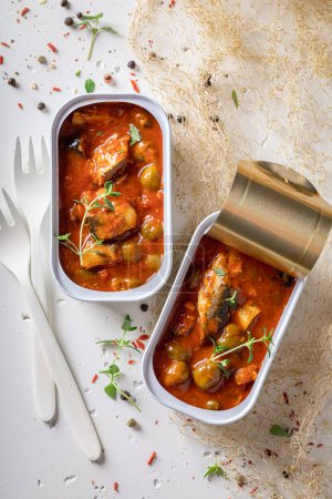 Delicious and healthy sprats as a healthy lunch. Sprats in can with spicy red sauce.