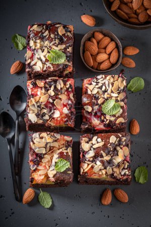Homemade and sweet brownie made of almond and fruits. Cake with fruits.