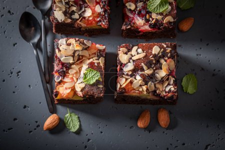 Fresh and delicious brownie with fruits and chocolate. Vegan fruit cake.