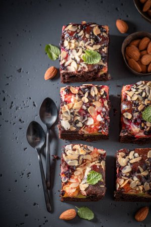 Sweet and tasty brownie with fruits and chocolate. Cake with fruits.