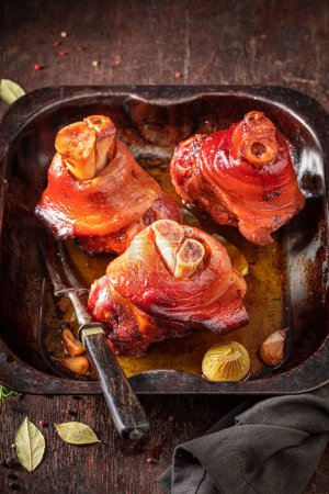 Tasty and grilled Schweinshaxe made of raw meat. Schweinshaxe with ingredients and spices.