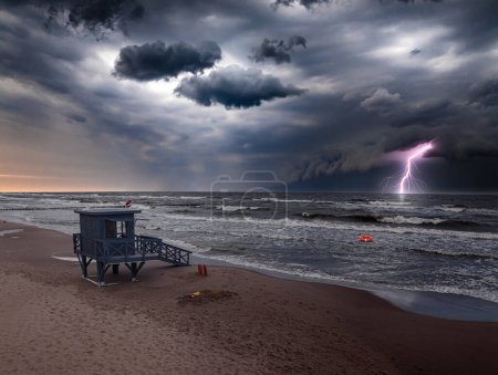 Lightning storm and lifeguard tower inundated by sea in Poland. Aerial view of Baltic sea after storm.