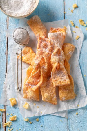 Fresh and sweet angel wings with powdered sugar. Traditional snack in Poland.