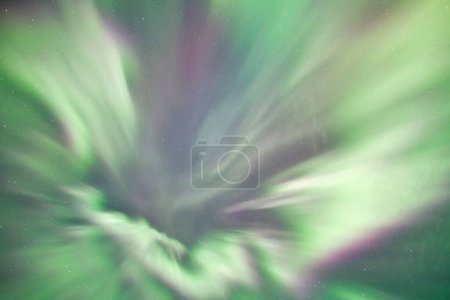 Colorful patterns of Northern Lights, Aurora Borealis, in an Alaskan sky with stars.