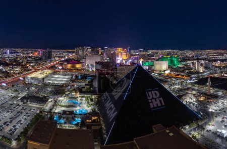 Téléchargez les photos : Une photo de Las Vegas la nuit, avec le Strip à l'extrême centre et la pyramide Luxor Hotel and Casino en bas. - en image libre de droit