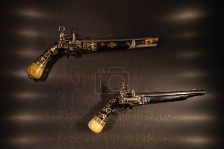 Photo for A picture of two pistols inside the Weapon and Armours room, part of the Topkapi Palace complex. - Royalty Free Image