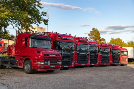 Photo for A picture of a row of red Scania trucks. - Royalty Free Image